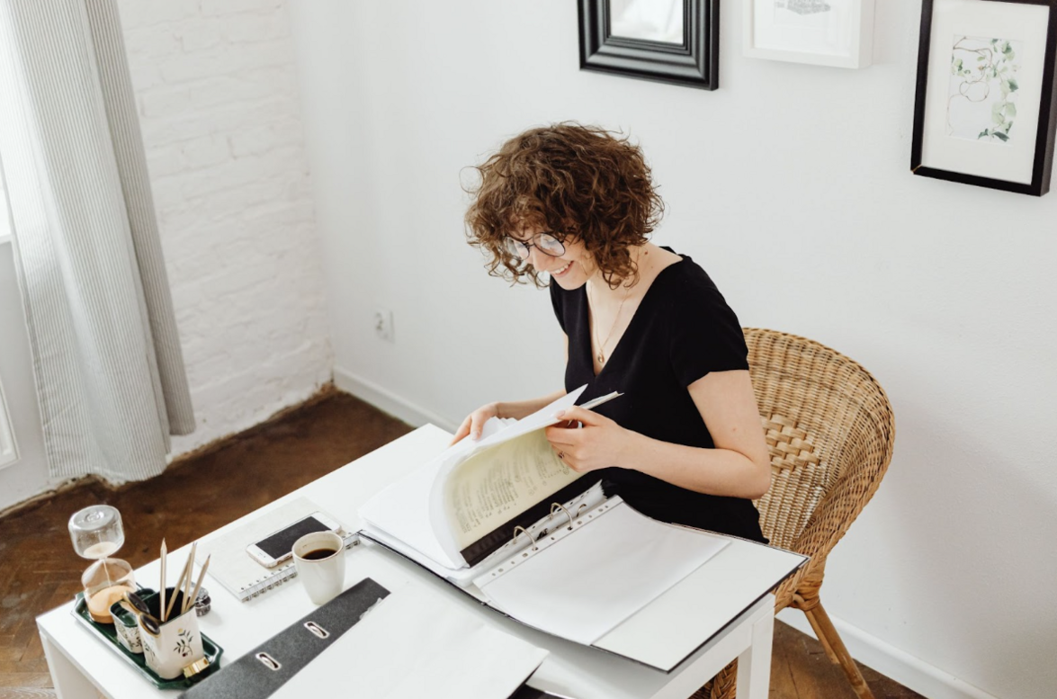 A marketing manager notes down what pages of her company's website need updated copy. Her outsourced content writing team will ensure they're in line with their brand tone & style.